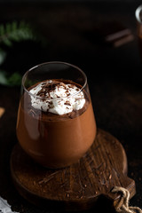 Dark moody style chocolate mousse on wooden board food photography