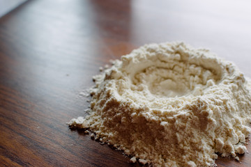 Flour on wooden board before preparing bread