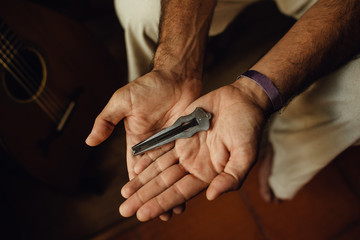 Hands of a musician holding a Jew's harp, or vargan