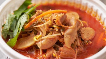 Korean spicy chicken soup in plastic bowl