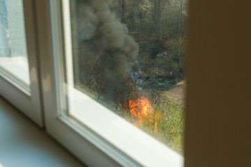 Wildfire near houses, view from the apartment window