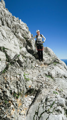 Woman's crossing the via ferrata trail in the alps