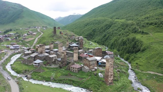Ancient stone towers and Ushguli village at the foot of Mt. Shkhara. Picturesque and gorgeous scene. Rock tower towers and old houses in Ushguli.