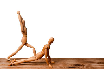 Wooden little men go in for sports isolated on white