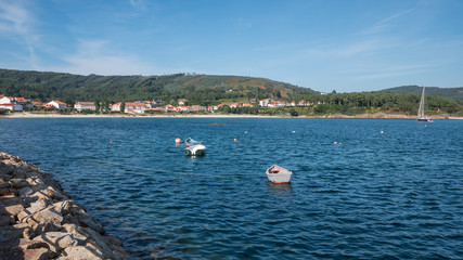 Fototapeta na wymiar View over Sardineiro do Abaixo, its beach and some small fishing boats, Fisterra, Galicia, Spain