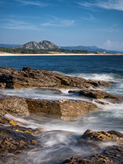 Long exposure image of waves and rocks at a beach of Carnota, Galicia, Spain