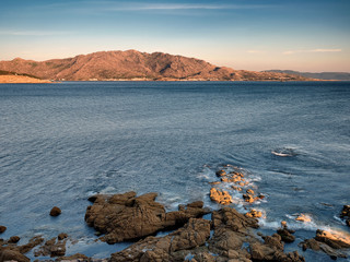 Sunset at the lighthouse of Cape Cee and view over Mount Pindo, La Coruña, Galicia, Spain