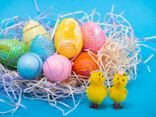 Easter eggs and chiks on blue background.