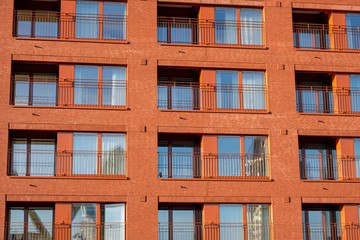 Facade of a modern red apartment house seen in Frankfurt, Germany