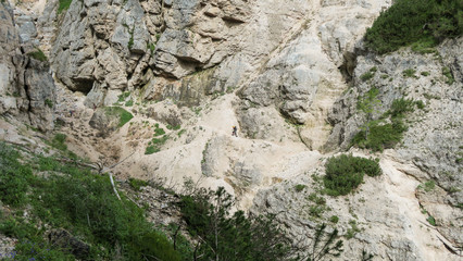 Going through a difficult trail in the full inventory located in the gorge. Dolomites in the Alps.