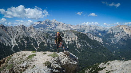 Fototapeta na wymiar Tourist with equipment on a mountain trail in the Alps
