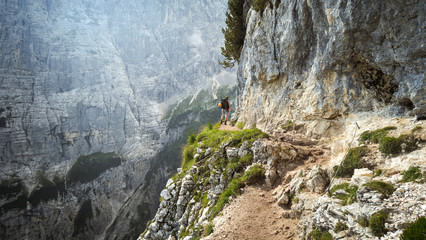 Tourist with equipment on the beautiful via ferrata trail in the alps