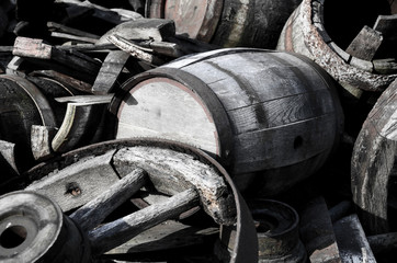 Abstract image with old wooden barrels of alcohol and wheels from the cart