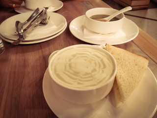 cup of cappuccino with sandwich and soup