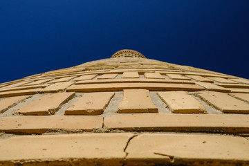 Brick wall of ancient minaret in Uzbekistan. Close-up view. Central Asia travel view