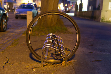 Abandoned bicycle wheel of a stolen bicycle, chain from front wheel.
