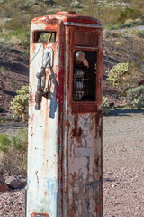 Vintage gasoline pump standing isolated in the desert by a roadside