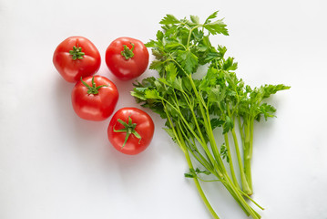 fresh vegetables tomato and parsley on a white background