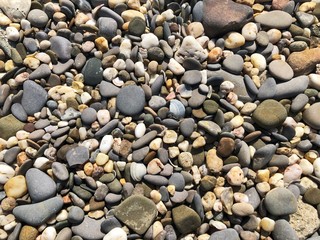 Pebbles on the beach. Abstract background with round pebbles stones