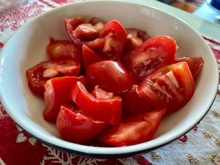 Fresh tomatoes cut in a ceramic bowl