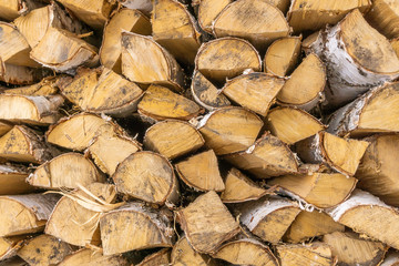 Log cuts. The texture of wood close-up, background a stack of firewood, stacked firewood.