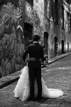 Married couple in a street full of graffiti 