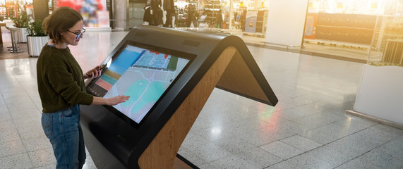 Woman uses the self-service kiosk