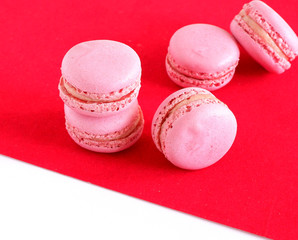macaroons on a red and white background. Sweets.