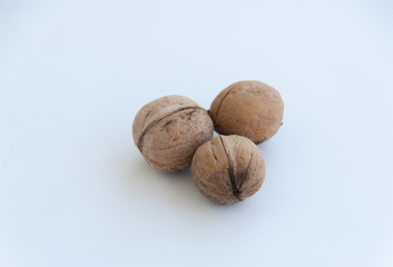 Three isolated walnuts on white background. Close up