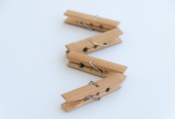 Wooden clothes pins in a zig zag shape. Isolated on a white background