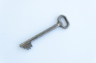 Vintage silver key isolated on white background. Close up. Top view