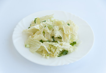 Fresh green salad on a white plate isolated on white background
