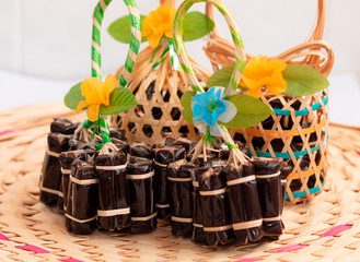 Close up view. Original Thai dessert wrap a bunch by binding bamboo fraction. And weave them into...