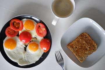 Breakfast: fried eggs, toast, coffee.