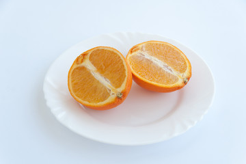 Naklejka na ściany i meble Freshly cut natural healthy juicy organic orange slices on a plate. Isolated on white background