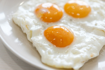 Three fried eggs for healthy breakfast.
