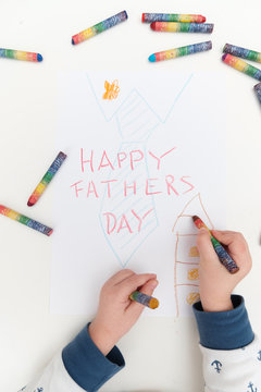 Unrecognizable boy painting picture for her dad, Fathers day. Concept for father's day celebration. Best father. Child and father concept. Son's hands with card for daddy. Boy and father..