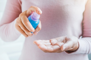 Woman hand Spraying Alcohol antiseptic solution skin disinfection to prevent viruses and diseases