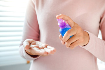 Woman hand Spraying Alcohol antiseptic solution skin disinfection to prevent viruses and diseases