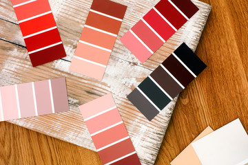 Multicoloured swatches on wooden plank.