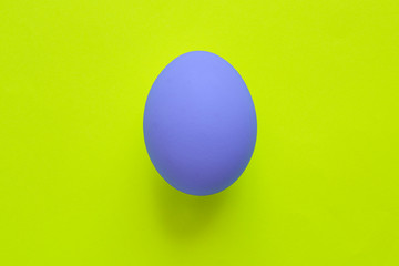 Blue easter egg on yellow background
