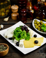 cheese platter with gouda white goat cheese and black olive