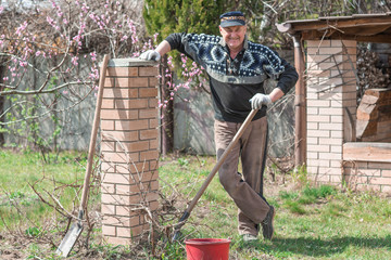 Senior man with working at garden, hobby time for older people