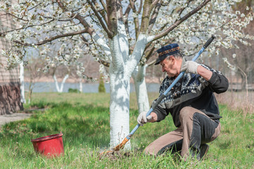 Senior man with working at garden, hobby time for older people