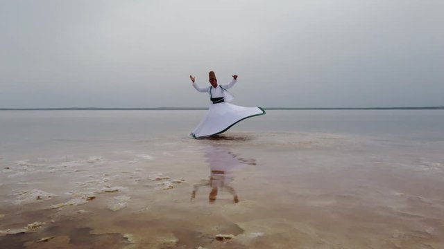 sunset and whirling at the sea, sufi. sufi whirling (Turkish: Semazen) is a form of Sama or physically active meditation which originated among Sufis. 4k