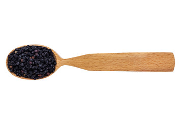 Dried Sambucus berries in a wooden spoon on a white background. Phytotherapy and disease prevention. Herbal collection for medicinal tinctures. Herbal tea in folk medicine. The view from the top
