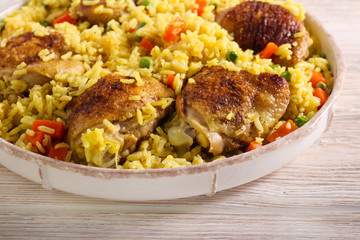 Chicken thighs with rice, carrot and peas