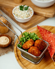 chicken nuggets in batter on a wooden board
