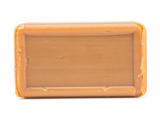 A piece of brown soap, isolate on a white background, close-up. Mockup, a place for your label. Soap as a means of hygiene and a way to protect against germs. Tar antibacterial baby soap