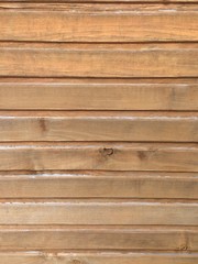a fragment of a wall paneled with wood panels with traces of aging
